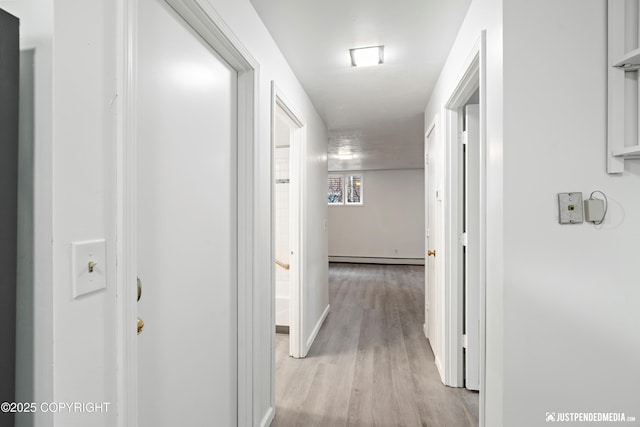 521 N St, Anchorage, AK 99501 - hallway with baseboards, light wood-style floors, and baseboard heating