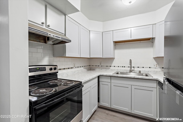 521 N St, Anchorage, AK 99501 - kitchen with decorative backsplash, under cabinet range hood, a sink, and electric range