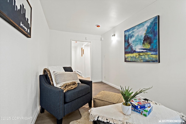 521 N St, Anchorage, AK 99501 - sitting room with baseboards, wood finished floors, and a baseboard radiator