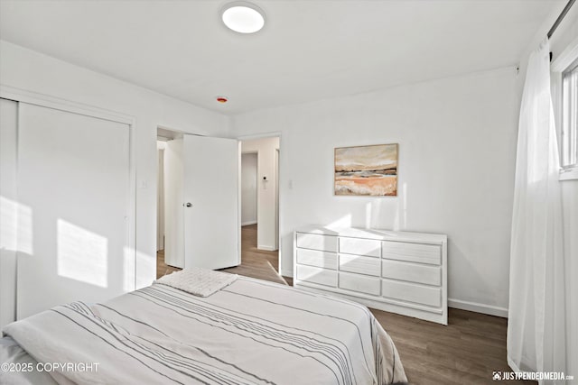 521 N St, Anchorage, AK 99501 - bedroom featuring baseboards, wood finished floors, and a closet