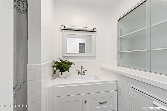 521 N St, Anchorage, AK 99501 - bathroom featuring tile walls and vanity