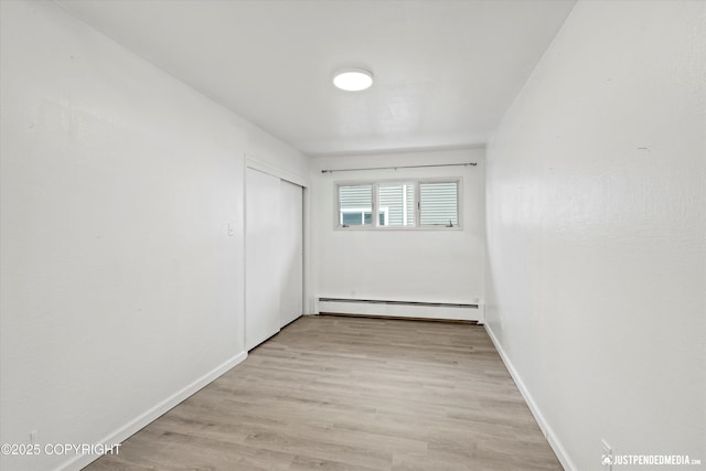 521 N St, Anchorage, AK 99501 - unfurnished room featuring baseboards, baseboard heating, and light wood-style flooring