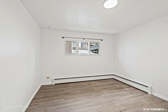 521 N St, Anchorage, AK 99501 - empty room featuring baseboards, wood finished floors, and baseboard heating