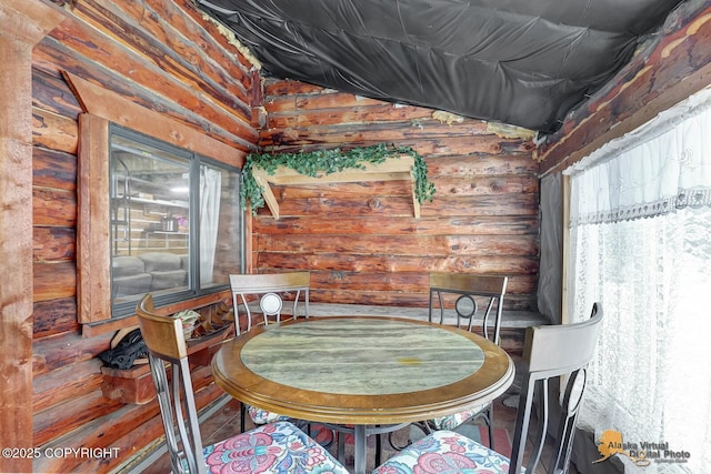 dining room featuring rustic walls