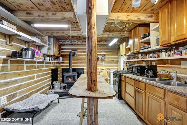 kitchen with black gas range oven, wood ceiling, a wood stove, open shelves, and a sink