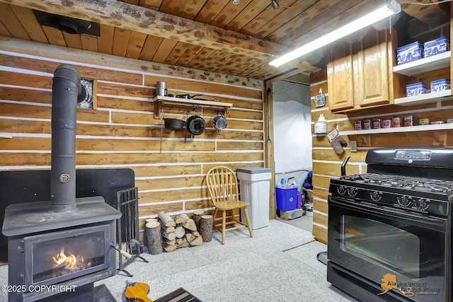 kitchen with wood ceiling, a wood stove, black gas range, and open shelves