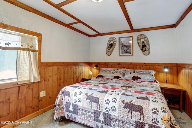 bedroom with a wainscoted wall, carpet, wooden walls, and beamed ceiling