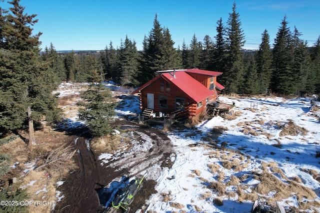 snowy aerial view with a forest view