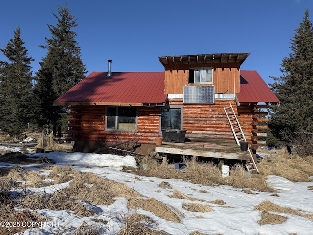 cabin featuring metal roof and log exterior