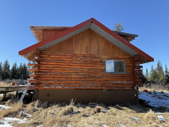 view of property exterior featuring log siding