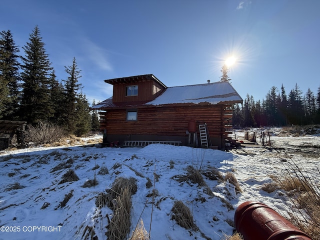 view of snow covered exterior featuring log exterior