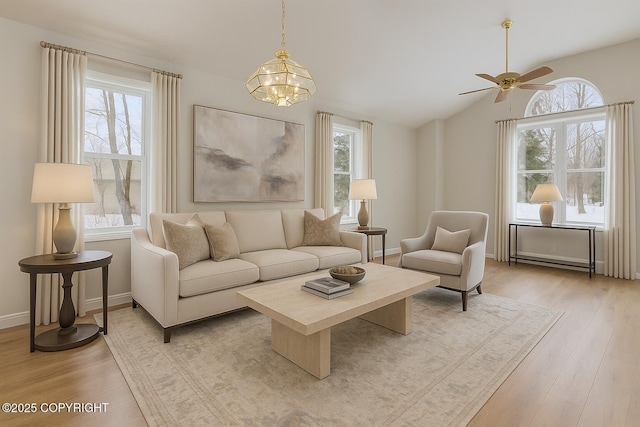 1301 Cross Rd, Anchorage, AK 99515 - living room featuring healthy amount of natural light, a chandelier, light wood-type flooring, and vaulted ceiling