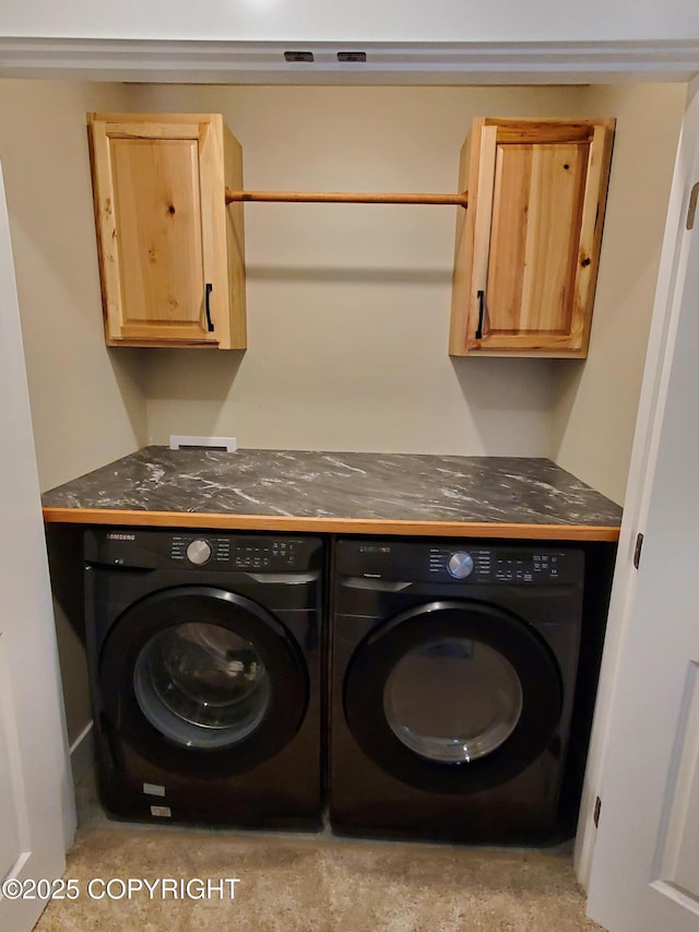 laundry area featuring cabinet space and washing machine and clothes dryer