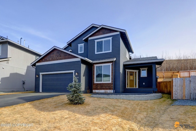 view of front facade with an attached garage, fence, and driveway