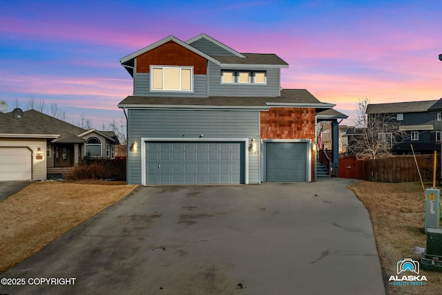 traditional-style home featuring a garage and driveway