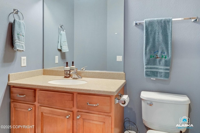 half bathroom featuring toilet and vanity