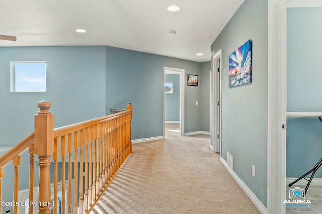 hall with visible vents, an upstairs landing, recessed lighting, carpet floors, and baseboards