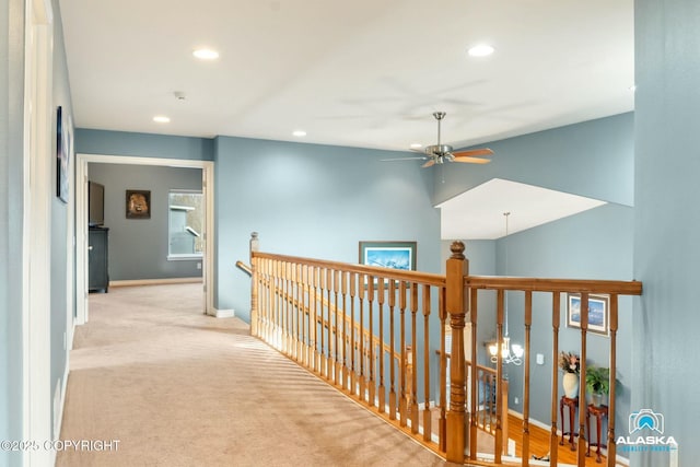 corridor with carpet, an upstairs landing, recessed lighting, and baseboards