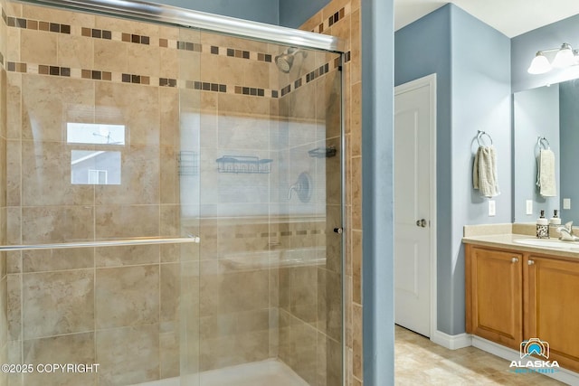 bathroom with a shower stall and vanity