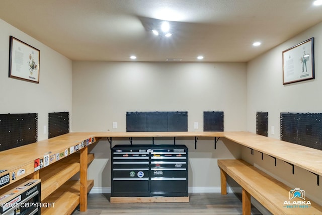 office featuring recessed lighting, visible vents, baseboards, and wood finished floors