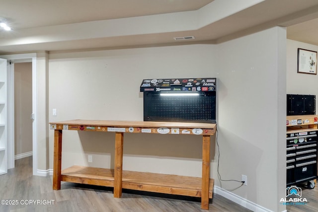 interior details featuring visible vents, baseboards, and wood finished floors