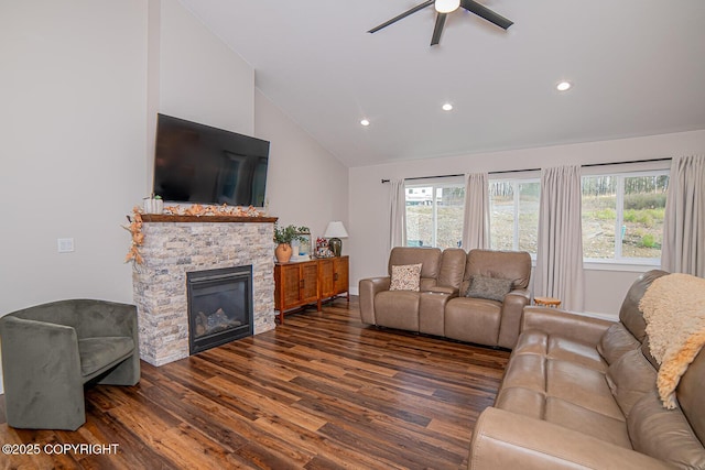 living area with lofted ceiling, dark wood-style floors, plenty of natural light, and a stone fireplace