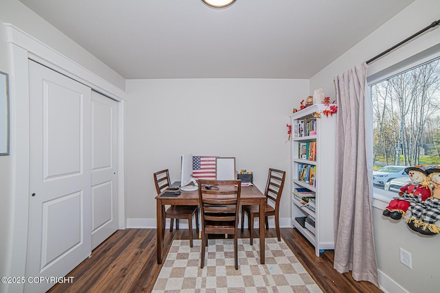 dining room featuring baseboards and wood finished floors