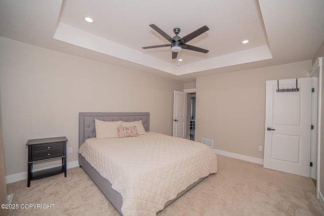 bedroom featuring recessed lighting, light carpet, visible vents, baseboards, and a raised ceiling