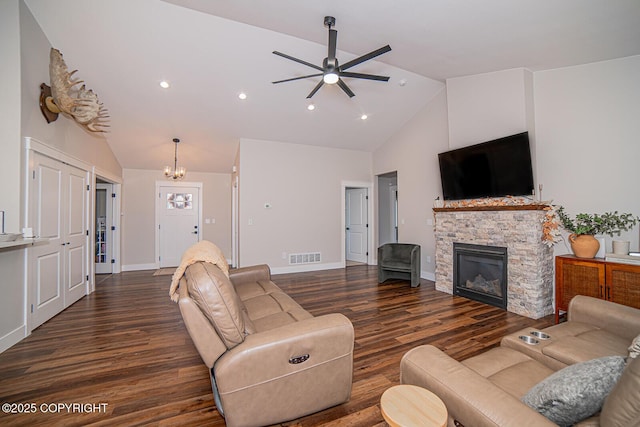 living room featuring baseboards, a fireplace, visible vents, and wood finished floors