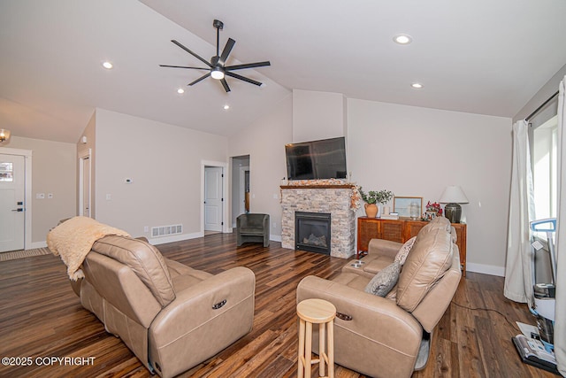 living area featuring dark wood-style floors, a fireplace, lofted ceiling, visible vents, and baseboards