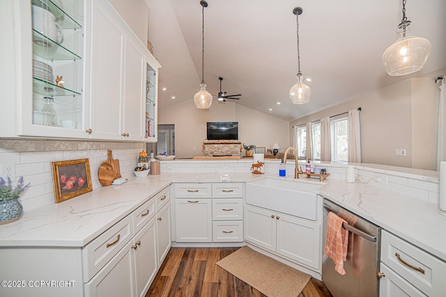 kitchen featuring dark wood-style flooring, hanging light fixtures, stainless steel dishwasher, white cabinets, and a sink