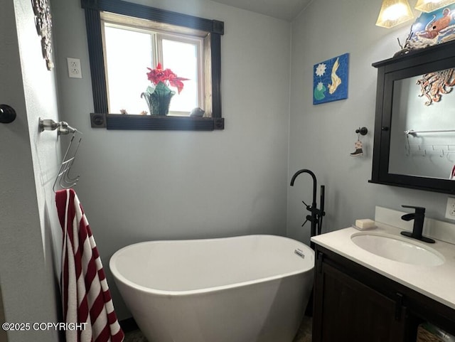 bathroom with a soaking tub and vanity