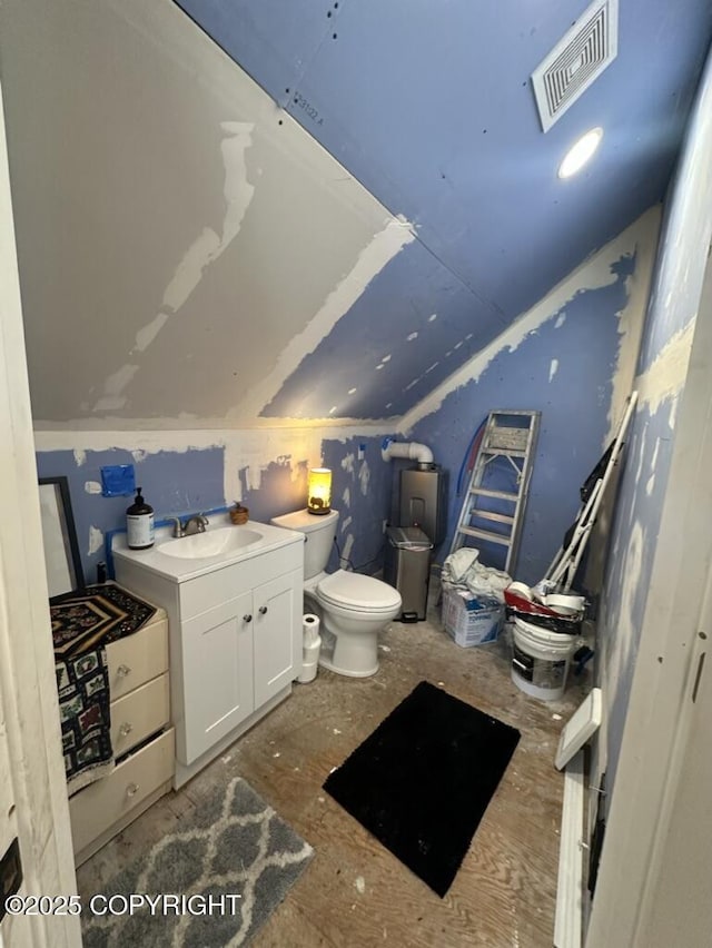 bathroom featuring visible vents, vaulted ceiling, vanity, and toilet