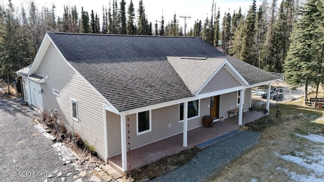 exterior space featuring a shingled roof