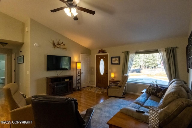 living area featuring ceiling fan, baseboards, lofted ceiling, and wood finished floors