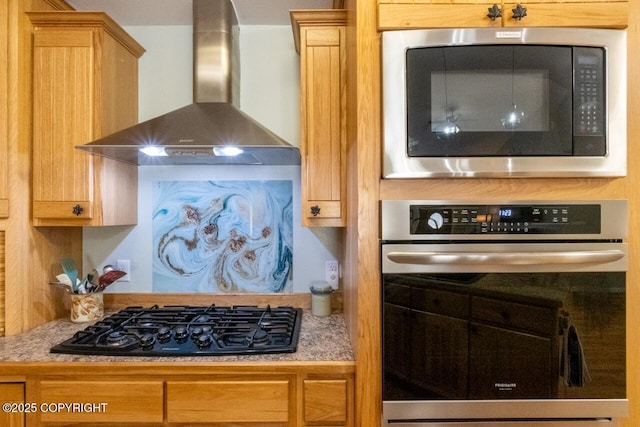 kitchen featuring light countertops, wall chimney range hood, and stainless steel appliances