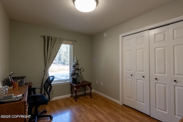 office area with baseboards and light wood-style floors