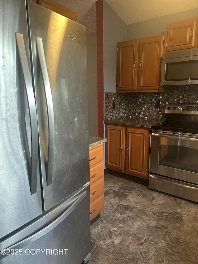 kitchen featuring stainless steel appliances and decorative backsplash