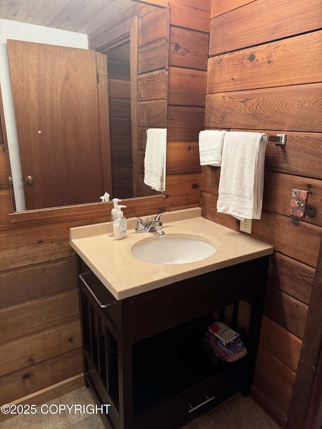 bathroom featuring wood walls and vanity