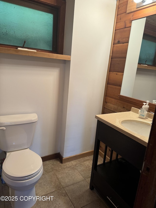 bathroom with toilet, baseboards, and vanity