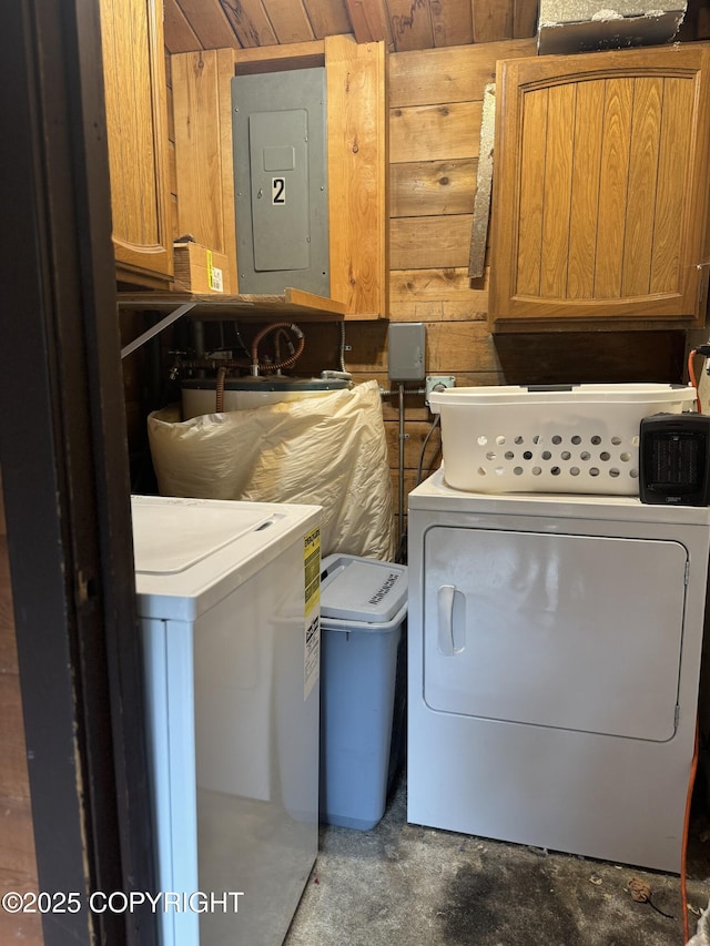 laundry room with electric panel, cabinet space, and washing machine and clothes dryer