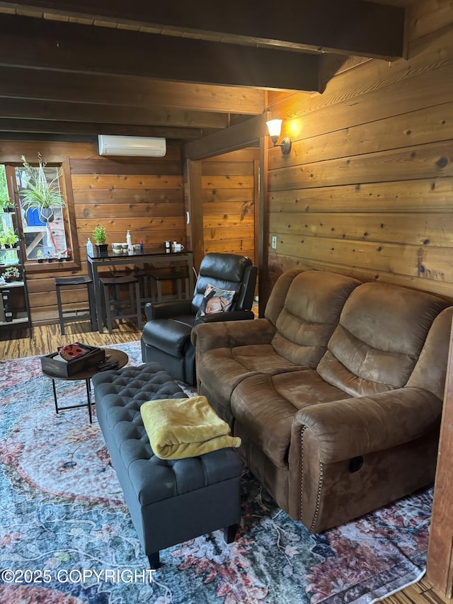 living area featuring wooden walls, wood finished floors, beam ceiling, and a wall mounted AC