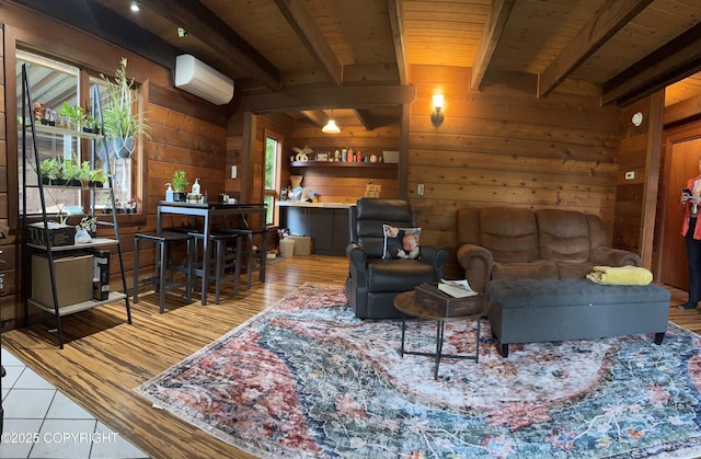 living area featuring beam ceiling, a wall mounted AC, wood ceiling, wood walls, and wood finished floors