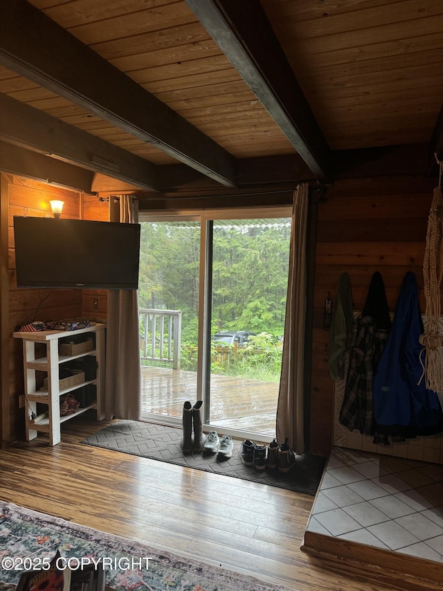 interior space with wooden ceiling, wood finished floors, and beamed ceiling