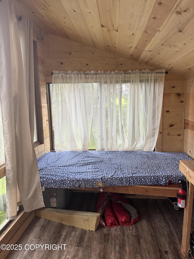 bedroom featuring lofted ceiling, wood ceiling, and wood finished floors