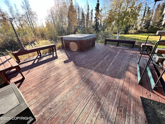 wooden deck featuring a hot tub