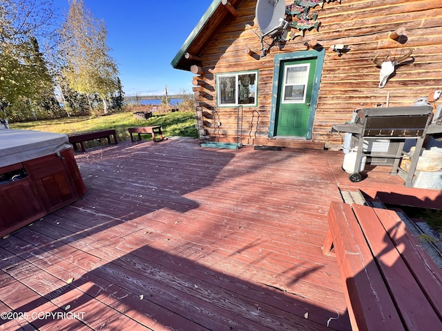 wooden deck featuring a hot tub and grilling area