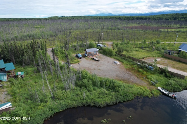 aerial view featuring a water view, a wooded view, and a rural view