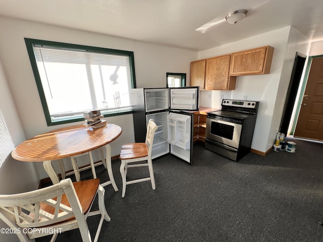 kitchen featuring stainless steel range with electric stovetop and baseboards