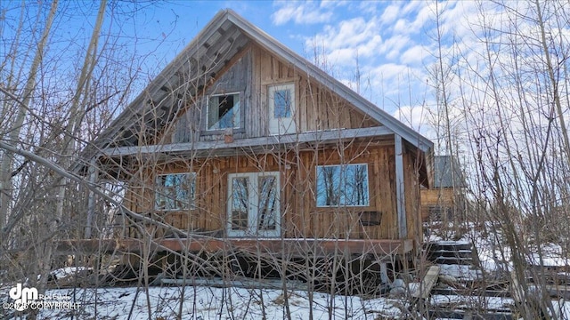 view of snow covered exterior with french doors